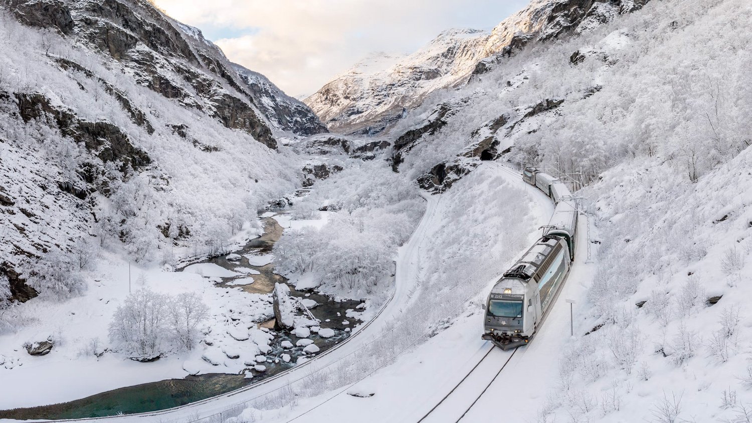 flam-train-through-snowy-mountain