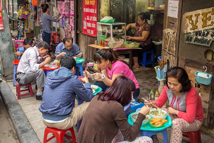 people-enjoying-street-food-hanoi-vietnam