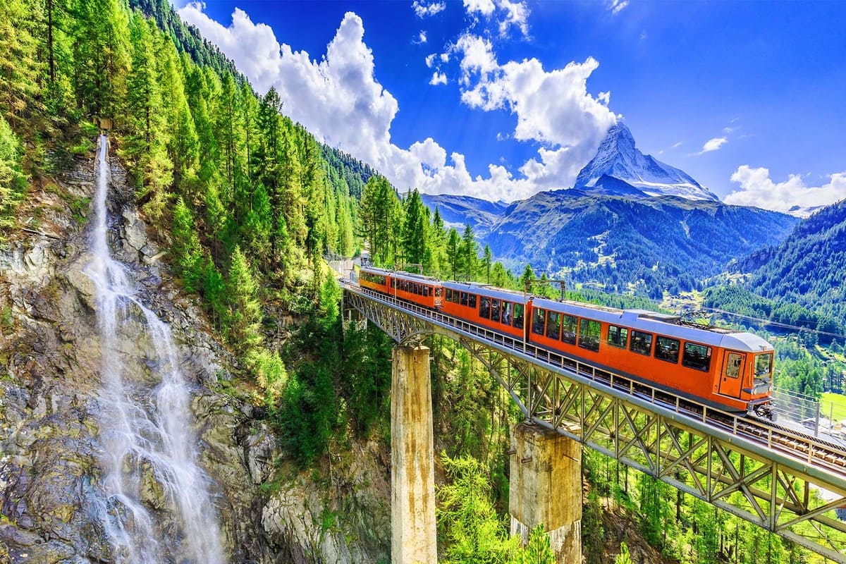 scenic-train-journey-through-mountains-and-waterfall